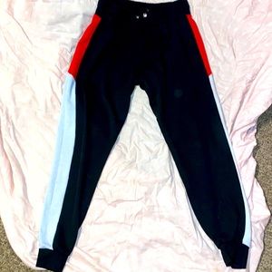 Black sweatpants with red and while down the side
